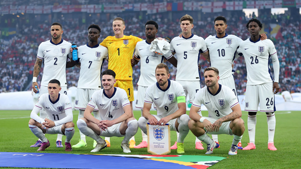 England national football team posing for a group photo on the pitch during a match.